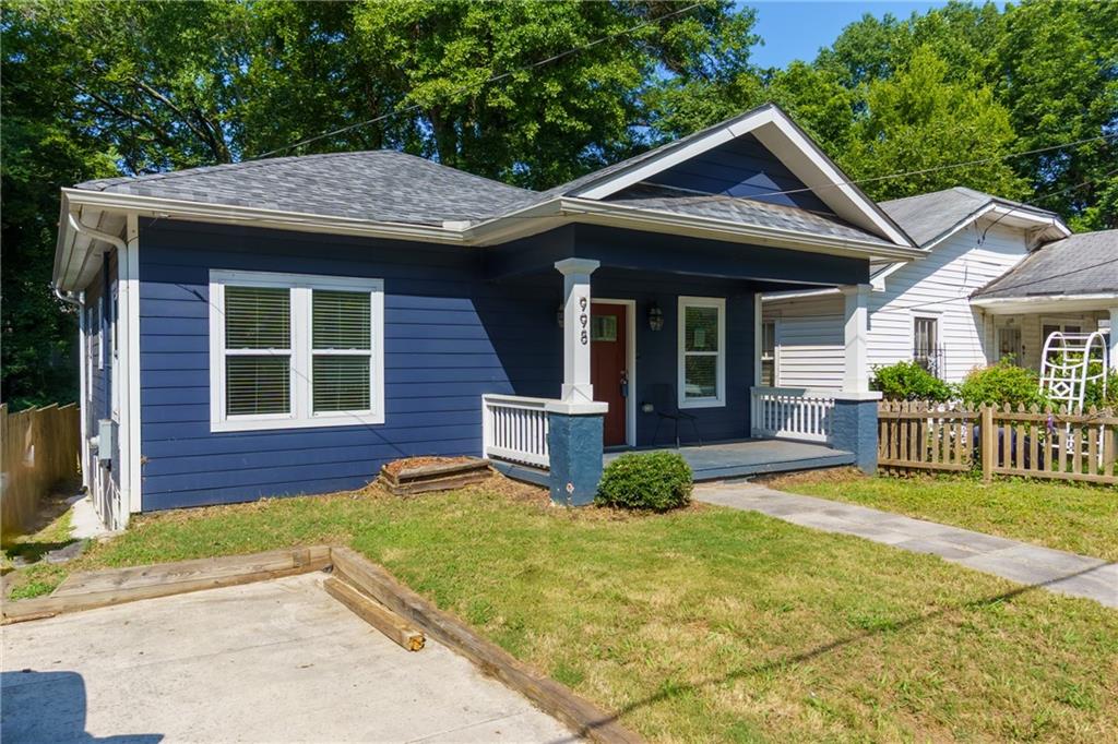 998 Mayson Turner Road Northwest, Unit A Atlanta, GA 30314 - Photo 2 of 26 a view of a brick house with plants and large tree