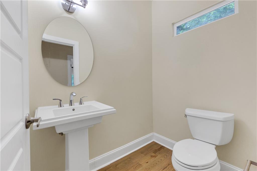998 Mayson Turner Road Northwest, Unit A Atlanta, GA 30314 - Photo 23 of 26 a bathroom with a toilet sink and mirror