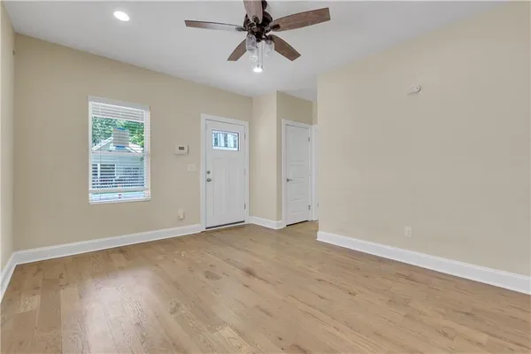 wooden floor in an empty room with a window