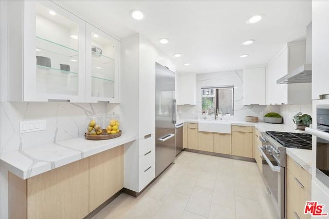 a kitchen with white cabinets and white appliances