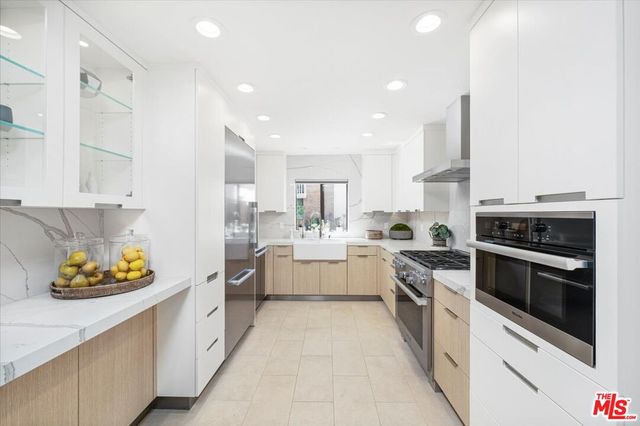 a large kitchen with stainless steel appliances kitchen island granite countertop a lot of counter space and cabinets