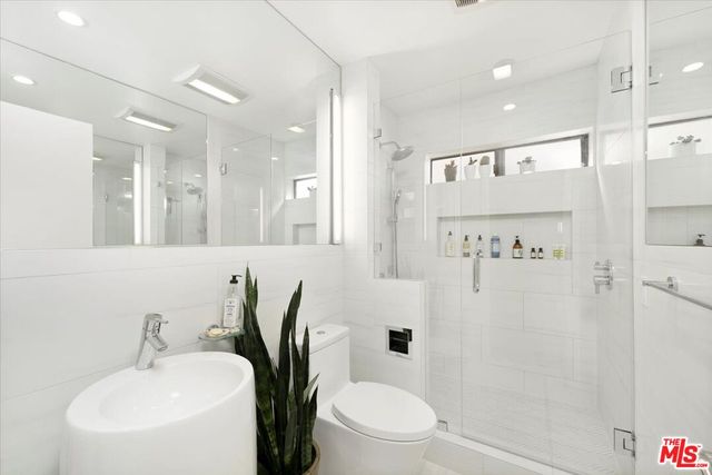 a bathroom with a toilet sink and shower