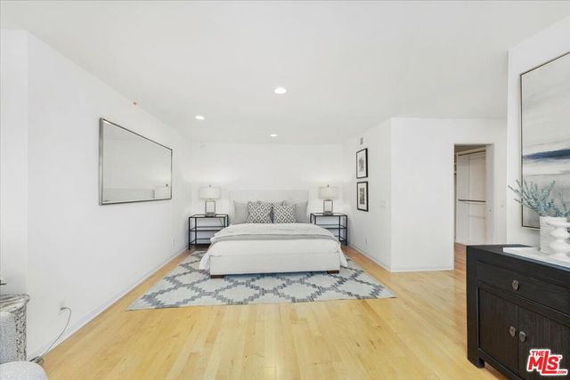 a spacious bedroom with a bed and a couch