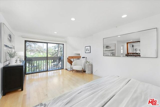 a bedroom with furniture and large window