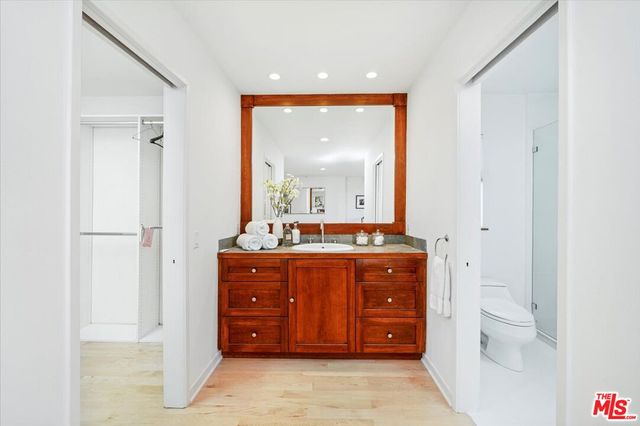 a spacious bathroom with a vanity and a mirror