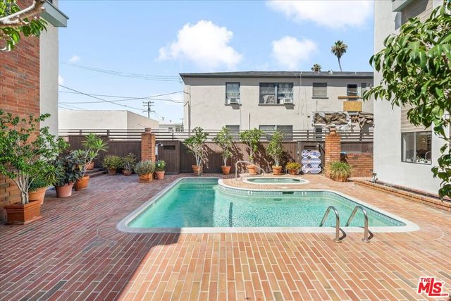 a view of a house with swimming pool and sitting area