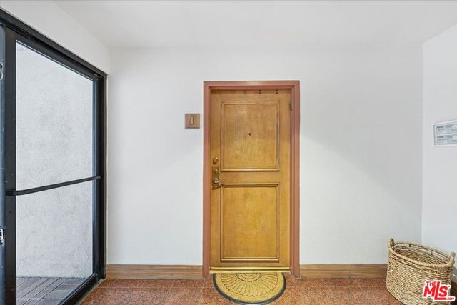 a view of a storage & utility room with a door