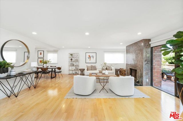 a view of a dining room with furniture a chandelier and wooden floor