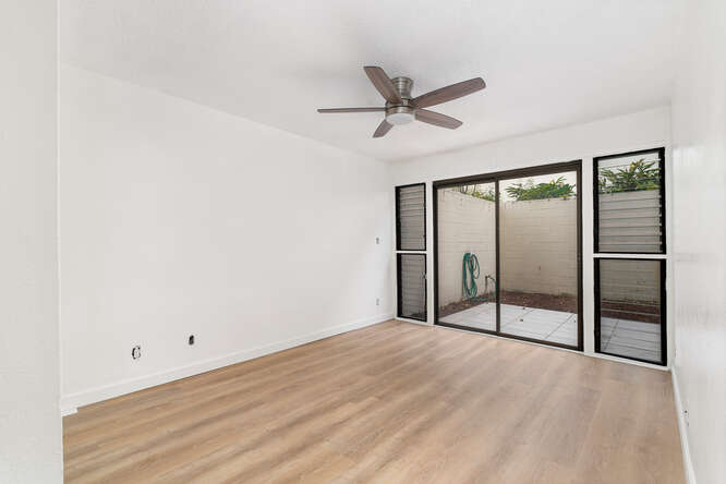 79-7199 Mamalahoa Highway, Unit 110 Holualoa, HI 96725 - Photo 13 of 26 a view of empty room with wooden floor and fan