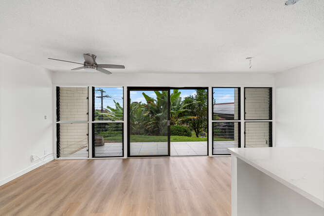 79-7199 Mamalahoa Highway, Unit 110 Holualoa, HI 96725 - Photo 18 of 26 a view of an empty room with wooden floor and a window