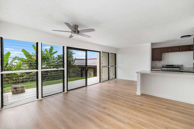 79-7199 Mamalahoa Highway, Unit 110 Holualoa, HI 96725 - Photo 2 of 26 a view of empty room with wooden floor and fan