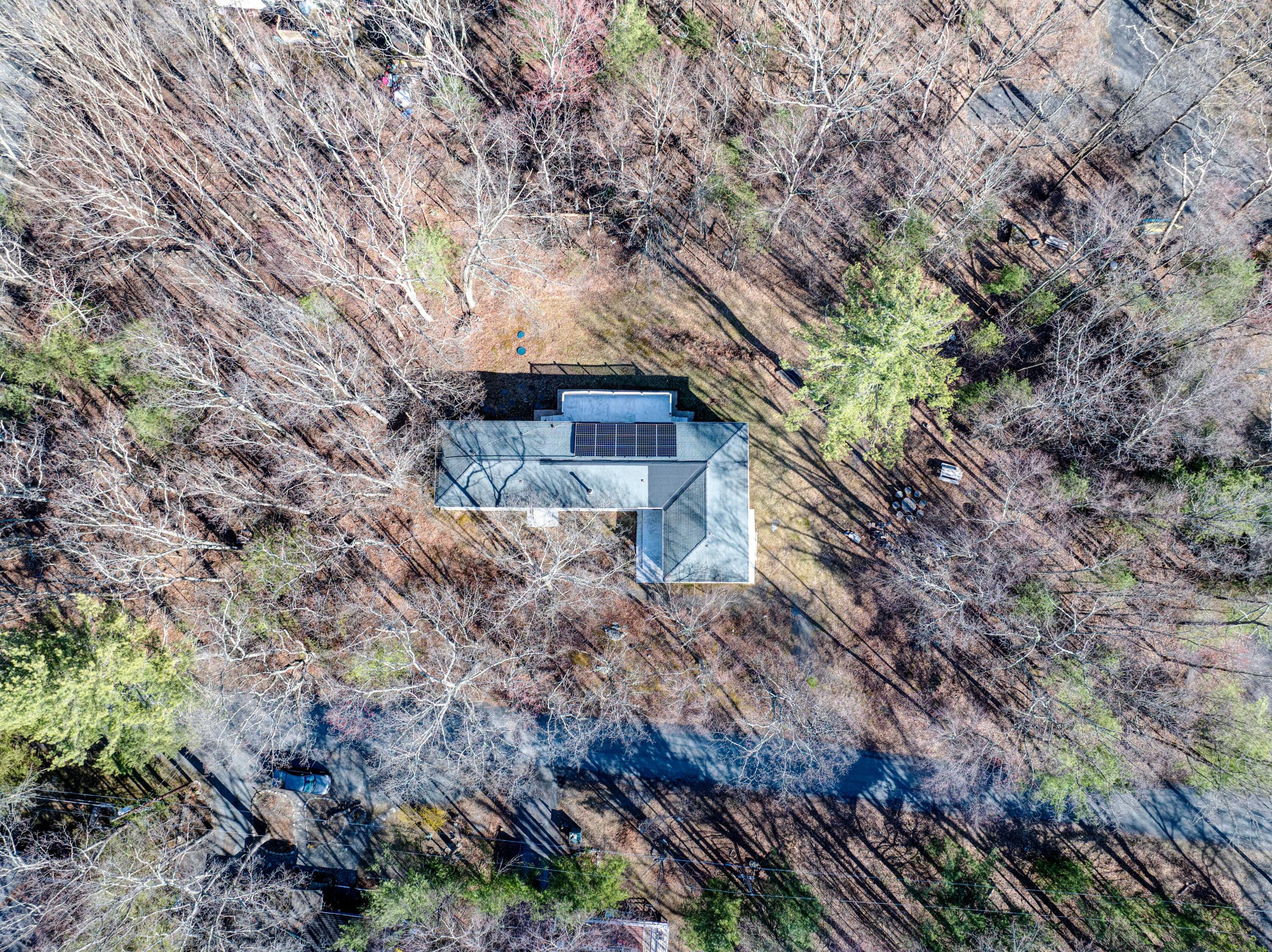 106 Dogwood Road Dingmans Ferry, PA 18328 - Photo 32 of 34 a backyard of a house with lots of plants and tree