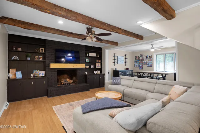 a living room with furniture and a fireplace