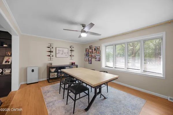a view of a dining room with furniture window and wooden floor