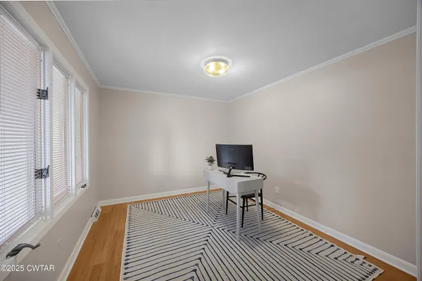 a view of a livingroom with wooden floor and a piano