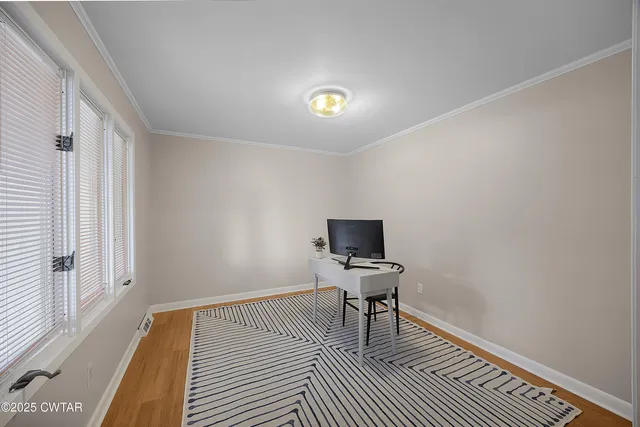 a view of a livingroom with wooden floor and a piano