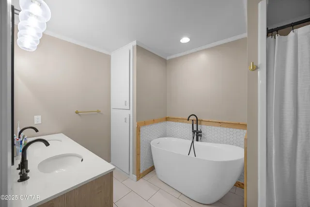 a bathroom with a sink and mirror