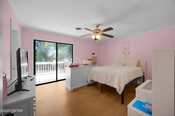 a bedroom with a bed and a large window with the outer view