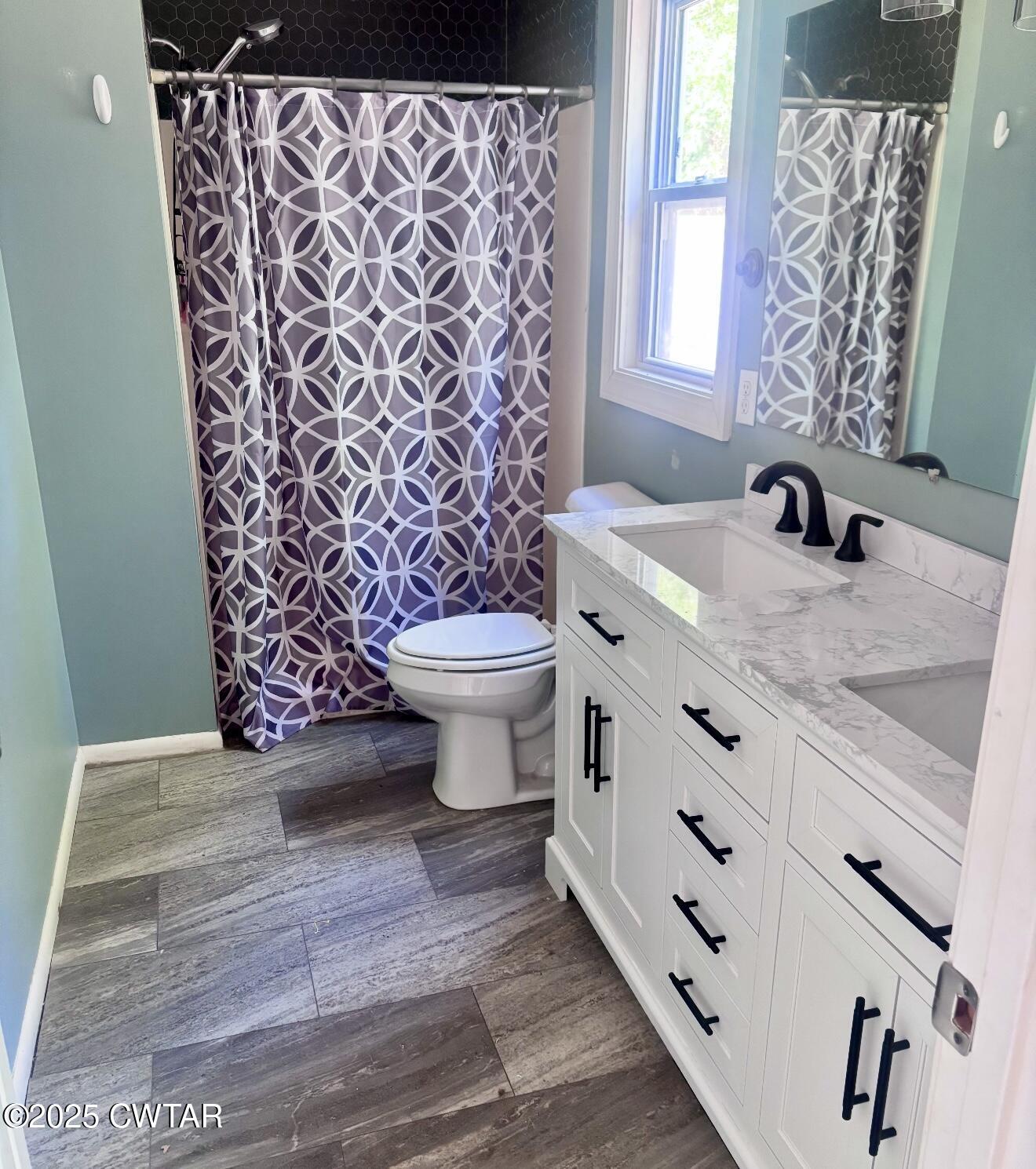 157 Mockingbird Lane Martin, TN 38237 - Photo 19 of 26 a bathroom with a granite countertop toilet a sink and a shower