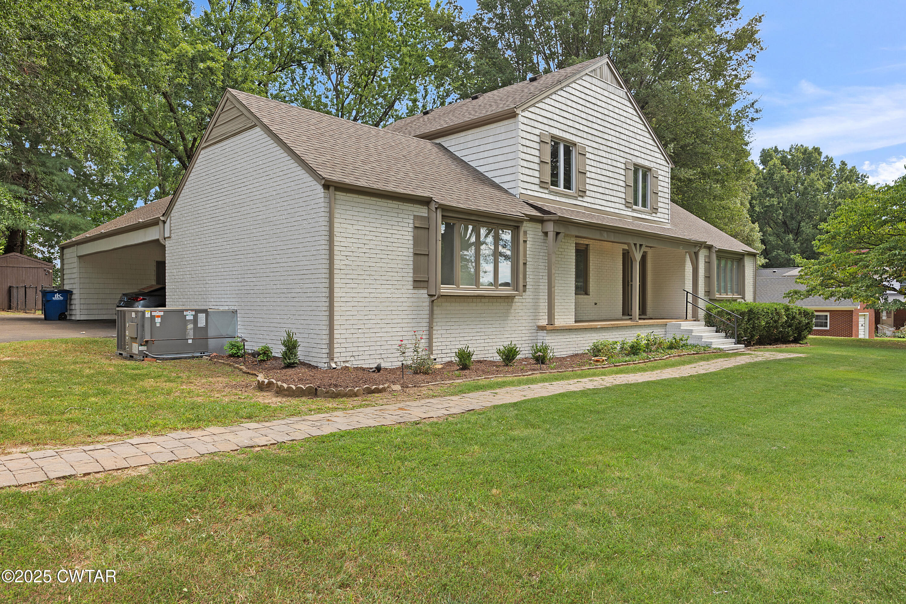157 Mockingbird Lane Martin, TN 38237 - Photo 3 of 26 a front view of a house with a yard and garage