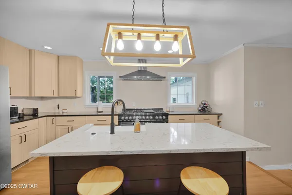 a kitchen with a sink a stove and window
