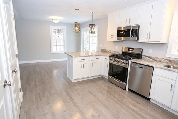 Lot 197 Stowell Road Ashburnham, MA 01430 - Photo 6 of 42 a kitchen with stainless steel appliances a stove a sink and a microwave