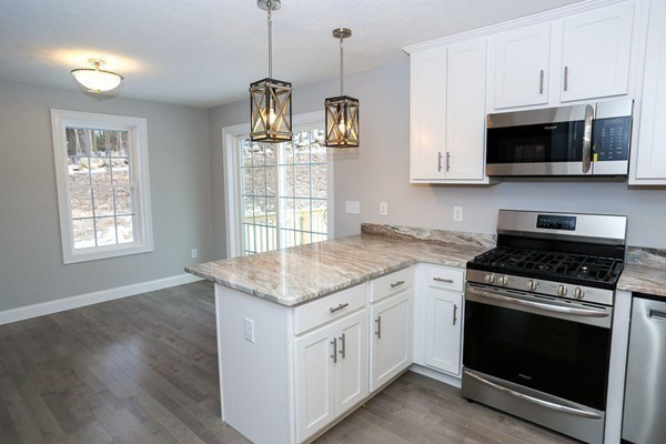 Lot 197 Stowell Road Ashburnham, MA 01430 - Photo 7 of 42 a kitchen with stainless steel appliances granite countertop a stove a microwave and a sink
