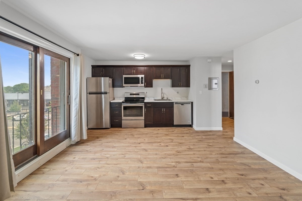 1030 Bennington Street, Unit 15 Boston, MA 02128 - Photo 3 of 12 a view of kitchen with stainless steel appliances granite countertop a refrigerator and a sink
