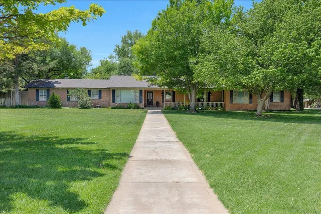 a view of house with a yard