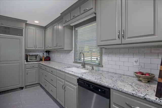 a living room with fireplace furniture and a flat screen tv