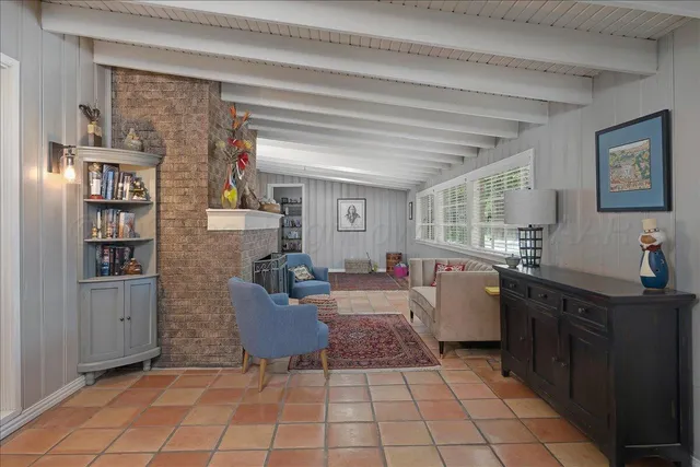 a view of an livingroom with furniture and a flat screen tv