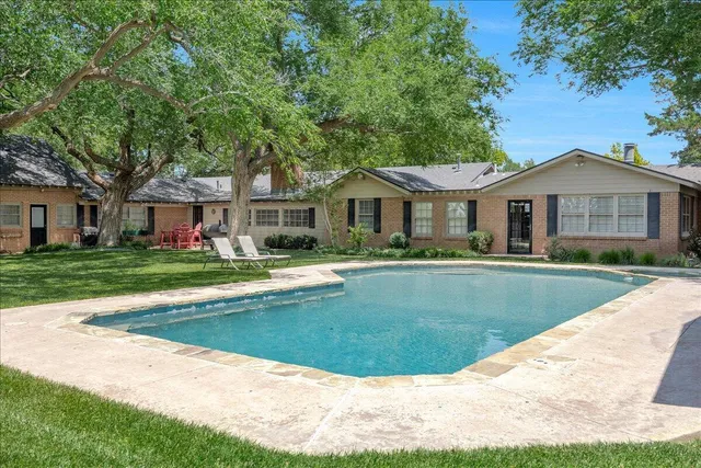 a view of house with a swimming pool