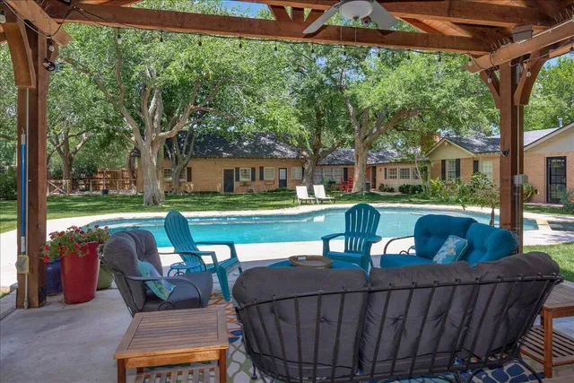 a view of a patio with table and chairs under an umbrella