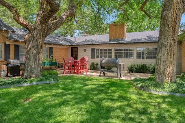 a house with a big yard and large trees