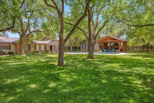 a front view of house with yard and green space