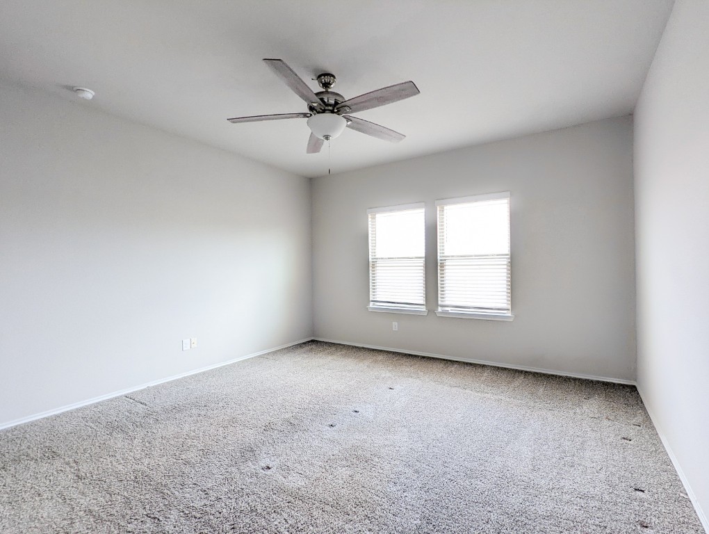 14541 Montclair Way Magnolia, TX 77354 - Photo 12 of 31 an empty room with windows and fan