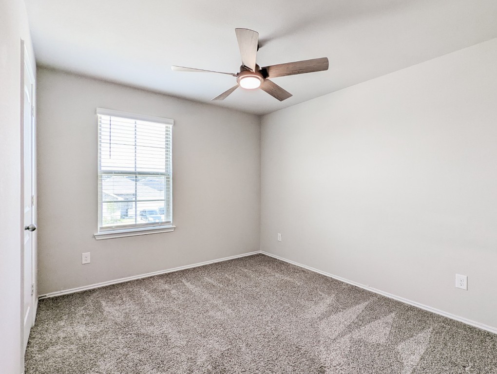 14541 Montclair Way Magnolia, TX 77354 - Photo 20 of 31 an empty room with a window and a fan
