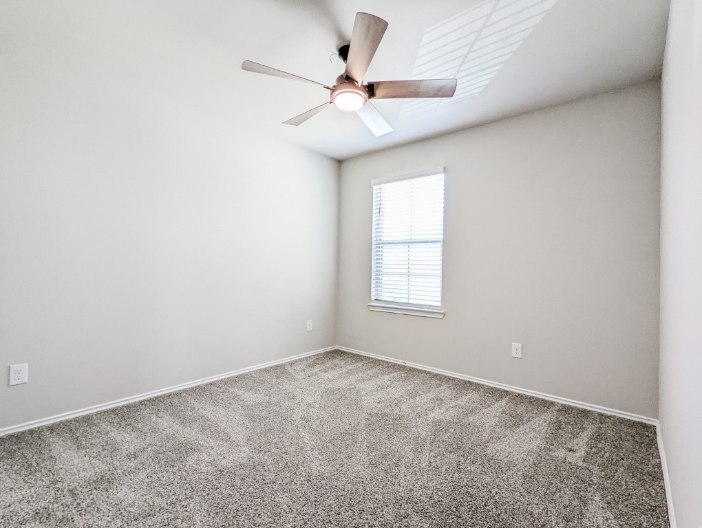 14541 Montclair Way Magnolia, TX 77354 - Photo 21 of 31 an empty room with a ceiling fan and window