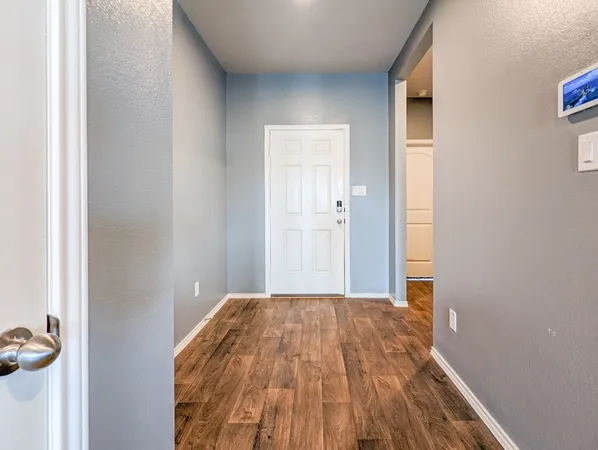a view of a room with wooden floor