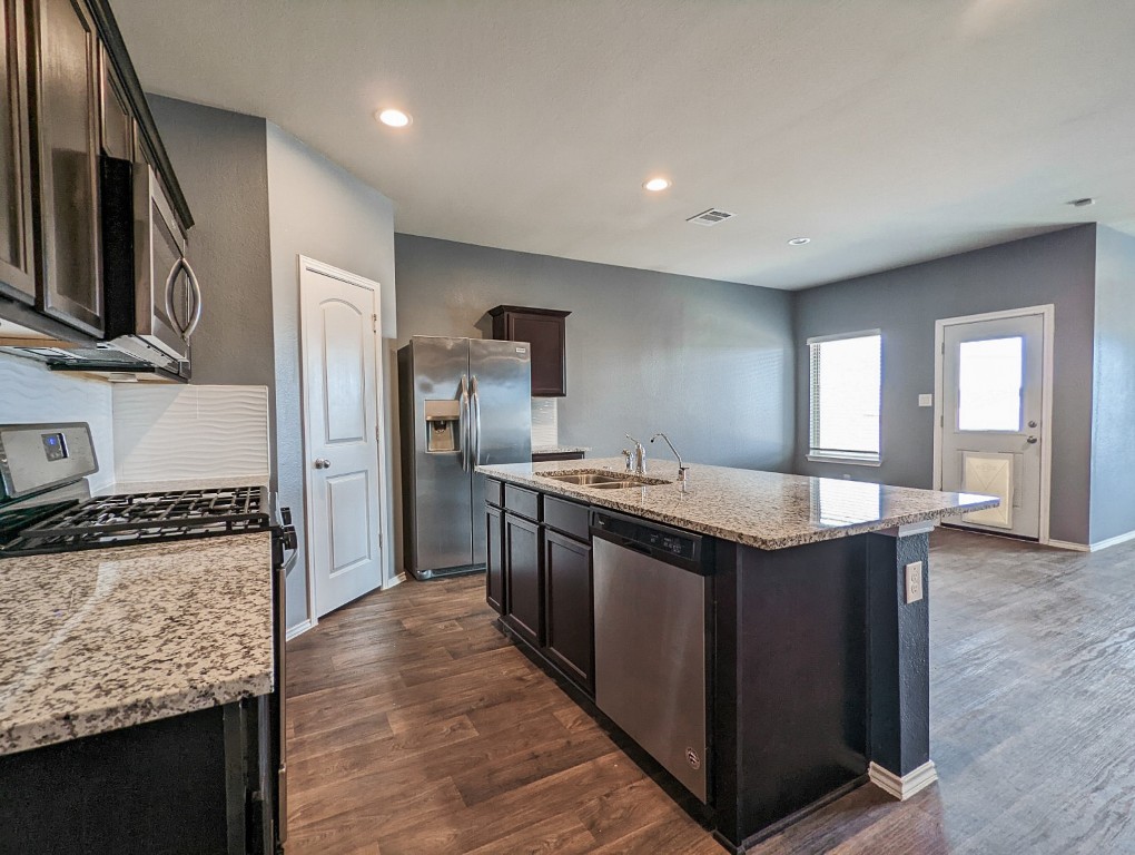 14541 Montclair Way Magnolia, TX 77354 - Photo 6 of 31 a kitchen with stainless steel appliances granite countertop a stove and a refrigerator