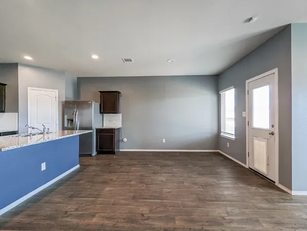 a view of kitchen with refrigerator microwave and cabinets