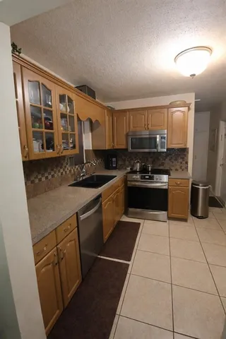 a kitchen with stainless steel appliances granite countertop a stove and a sink