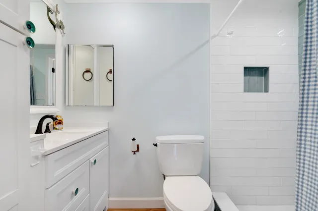 a white toilet sitting next to a bathroom sink