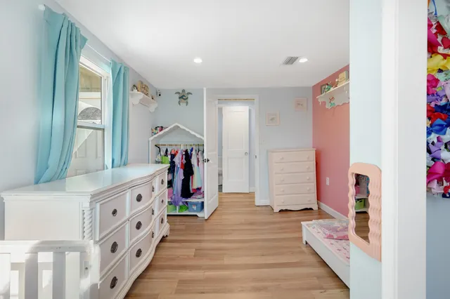 a hallway with cabinets and wooden floor