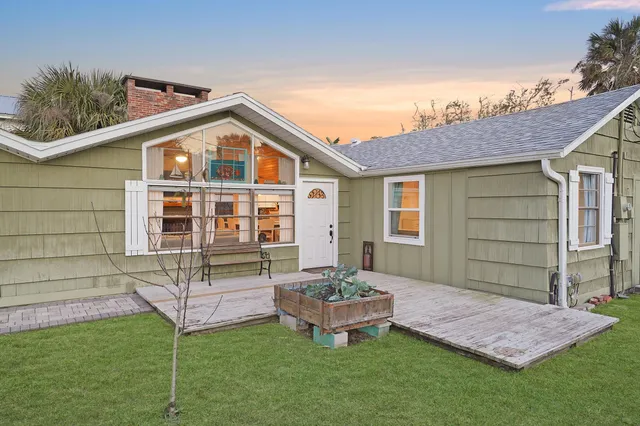 a backyard of a house with table and chairs