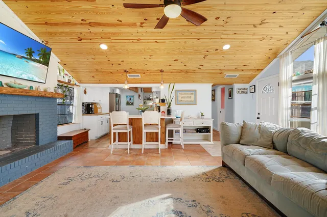 a living room with furniture a fireplace and a table