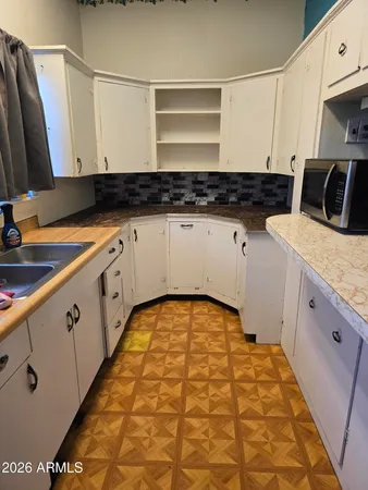 a kitchen with a sink and cabinets