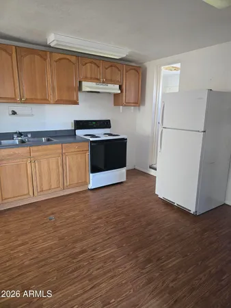 a kitchen with granite countertop a refrigerator and a stove