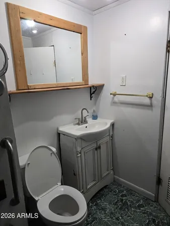 a bathroom with a toilet a sink and mirror