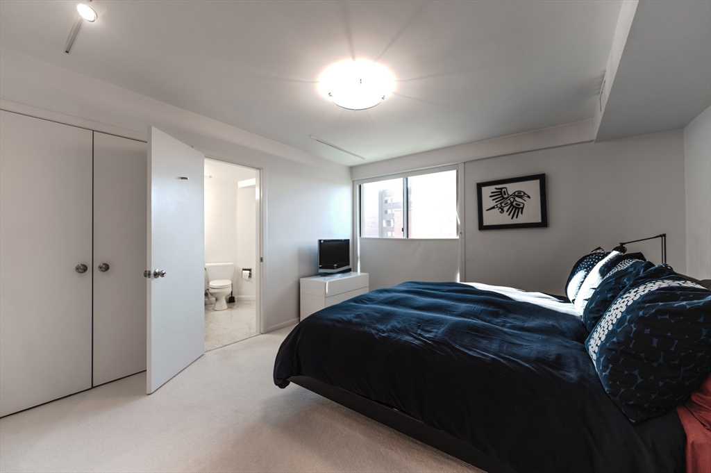 1010 Memorial Drive, Unit 6G Cambridge, MA 02138 - Photo 14 of 22 a bedroom with a bed and a window